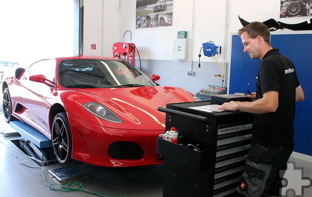 Marcus Schiffer testet am Montageplatz in der Werkstatthalle das Fahrwerk und das Fahrzeuggewicht des roten Ferraris. Foto: Steffi Tucholke/pp/Agentur ProfiPress
